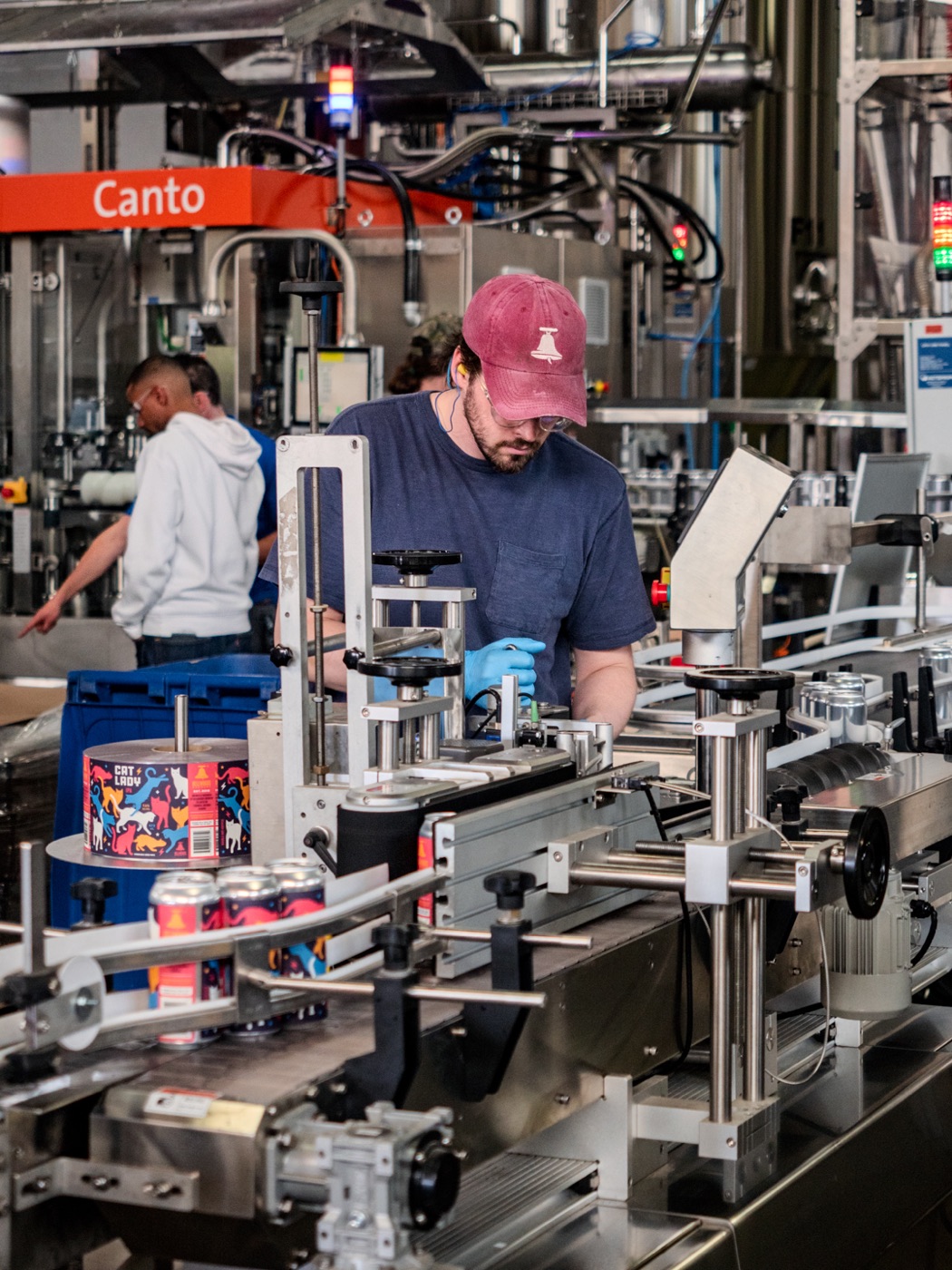 A brewer running the canning line at Hafis Road