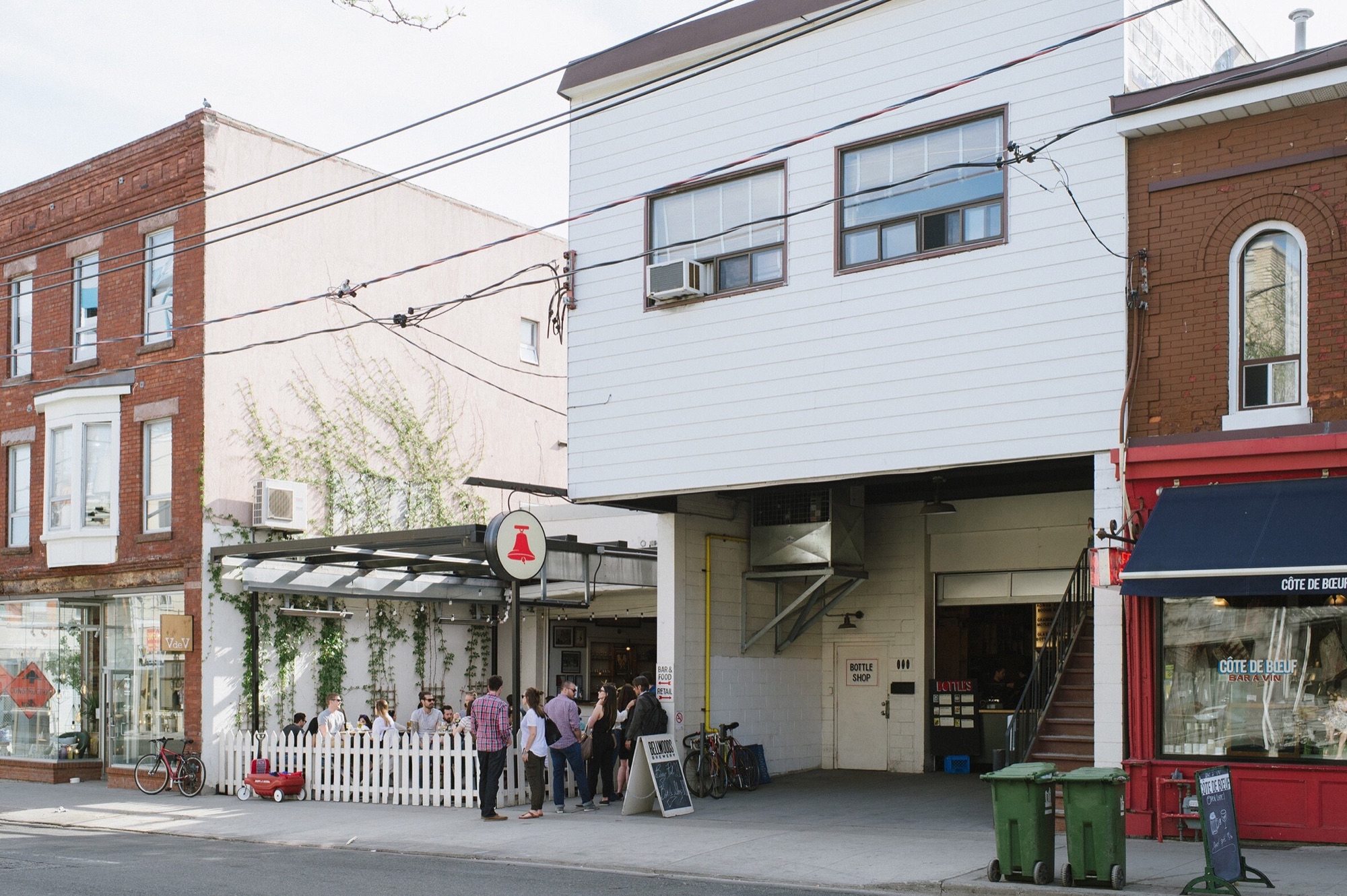The original Bellwoods brewery on Ossington Avenue, behind its white picket fence